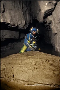 Figure 2: The scalloped bedrock floor of Joint Hole in Chapel-le-Dale is partially covered with sand and gravel clasts, which are actively transported during periods of high discharge