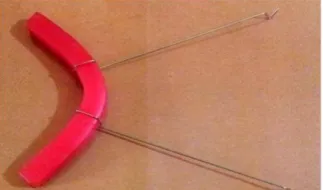 Fig 15: The upper u-shaped wax block with 2 wires attached to it and emerging outward to hold the metal frame