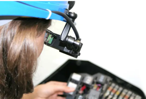 Figure 4. View of the user through the HMD. The buttons (arrows) are used to toggle to the next or previous task