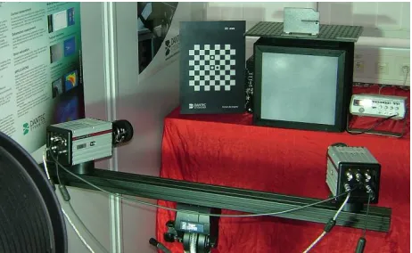 Fig. 3. Experimental setup with high-speed cameras, calibration target, loudspeaker and  frequency generator for vibration measurement