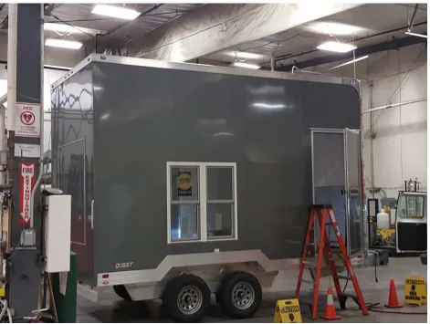 Figure 11: Exterior view of MDL trailer with removable wall section visible on the left wall behind the white hanging box