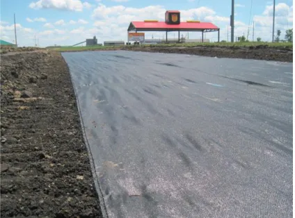 Figure 4 shows a woven geotextile placed at the interface of the subgrade and limestone subbase layer in Boone County, Iowa