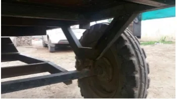 Fig. 1 shows that joint between the agricultural trolley and chassis is rigid. 