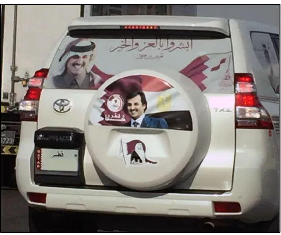 Figure 2. On tire cover: Qatari flag (left) and Egyptian flag (right),  with the Amir in the middle; across back window: “Expect Glory and Prosperity.” 