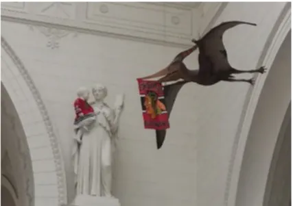 Fig. 1.3. Pterodactyl with Chicago NHL team flag and baby statue wearing jersey in Stanley Field Hall