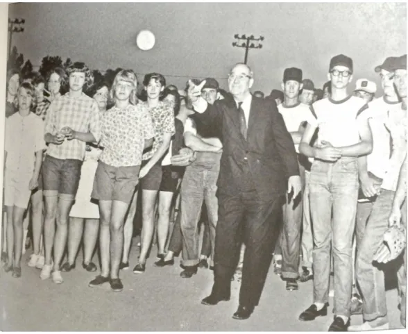 Figure 7: B Everett Jordan throws the first pitch at a company team baseball game.  