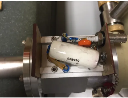 Figure 2.9: Inside of VT-1 HV filter. Note the grey residue on the large white capacitor.