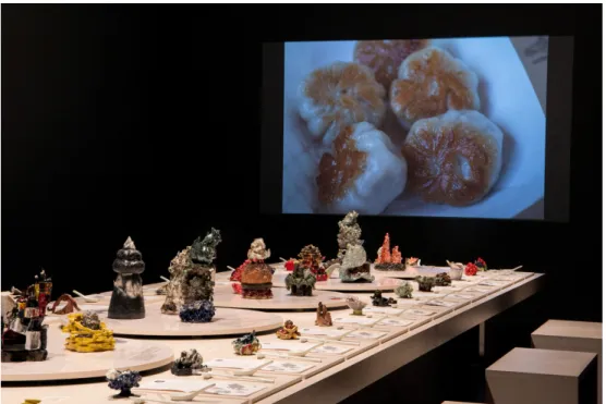 Fig. 4 – View of the video installation and ceramic table of Sour, Sweet, Bitter, Spicy: Stories of Chinese Food and Identity in America, courtesy of the Museum of Chinese in America.