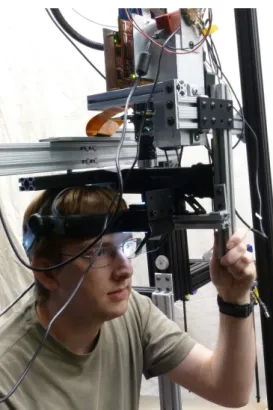 Figure 1.3: A user “wearing” our AR display. The monocular virtual imagery is presented to the user’s left eye.