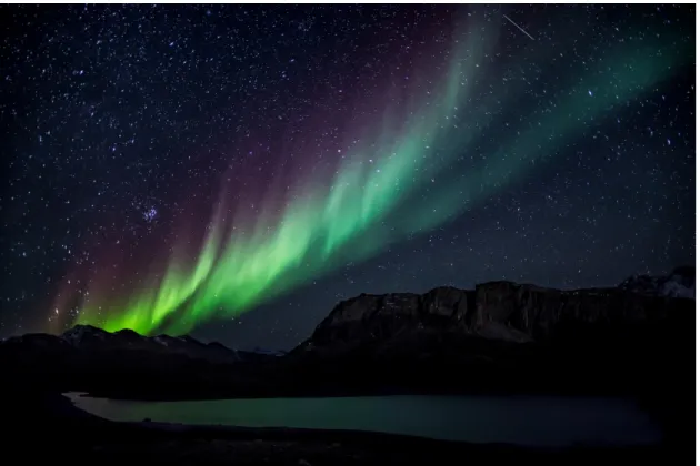 Fig. 1.1 The aurora borealis, also known as the “northern lights”, are caused by ionization  and excitation of the electrons in atmospheric molecules by charged particles in the solar  wind