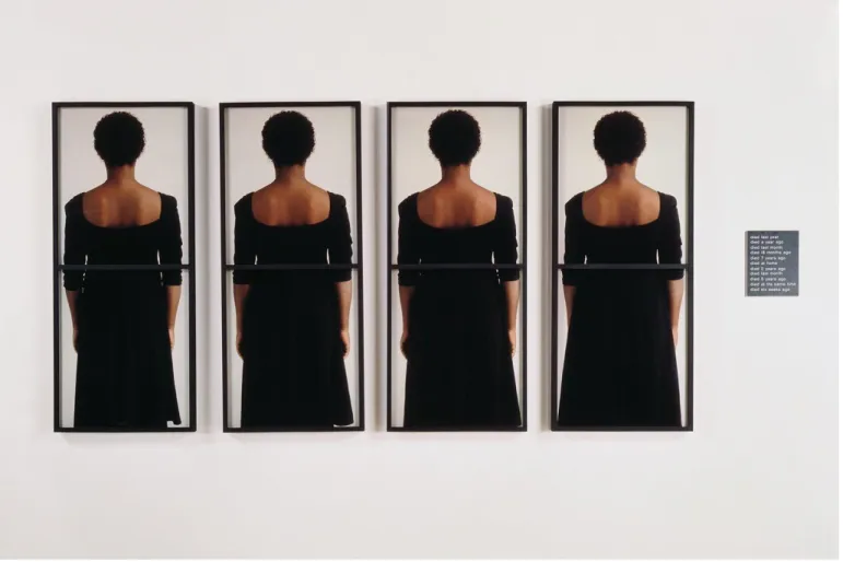Figure 2: Lorna Simpson, Time Piece, 1990, 8 dye diffusion color Polaroid prints, 1 en- en-graved plastic plaque, 125.1 x 128.5 x 1.875 inches
