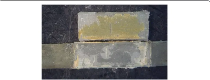 Figure 4 Optical microscopic images of a Co-Cr alloy without bonding agent application (G4) afterflexural bond strength test, showing opaque layer remnants on metal surface (mixed failure).