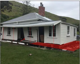 Figure 1.13 - Tsunami damage to the cottage at Little Pigeon Bay. The red area and lines are where the veranda and poles were (GeoNet, n.d)