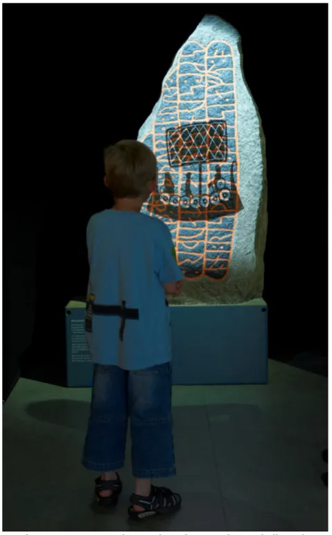 Figure 6. Interactive animation projected directly onto the authentic runic stone.  Photo: Museum Østjylland (East Jutland Museum), Denmark
