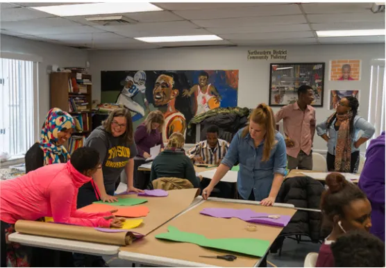Figure 4. Students and teachers busy at work on their visual art installation during an all-day Saturday gathering at a local community center