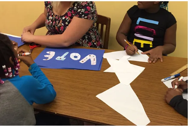 Figure 9. Working on a teacher requested “vote” poster in early field experiences. 