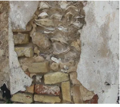 Figure 4.2 Fort Keta’s Wall   An exposed wall, washed away by the sea, shows the use of foreign brick and local oyster shells in the building’s walls