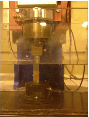 Figure 4.2: Electric discharge setup.  The steel work-piece  rotates while the copper tool electrode is anchored to tank base
