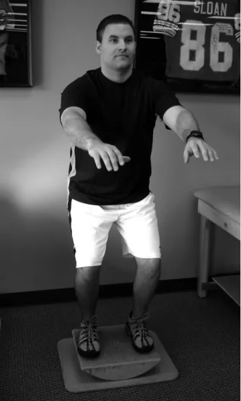 FIGURE 6. Mini-squats on an unstable surface such as a tilt-board.