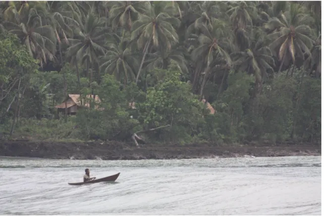 Figure 3.6: Man going fishing in typical dugout canoe with no out-rigger.  There can be large swells in Kahua making sea travel difficult