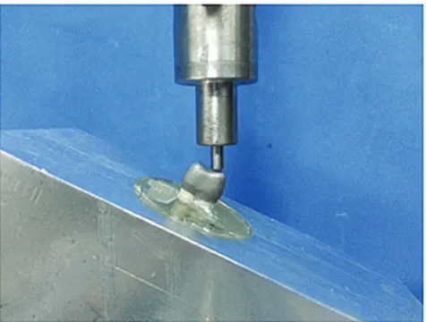 Fig. 1. The position of a specimen in a customized metal holder in a universal testing machine for static loading at 25°