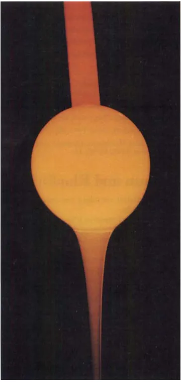 Fig. 9 ball A platinum A.C.T."' coated ceramic gathering streaming molten glass, during service trials 