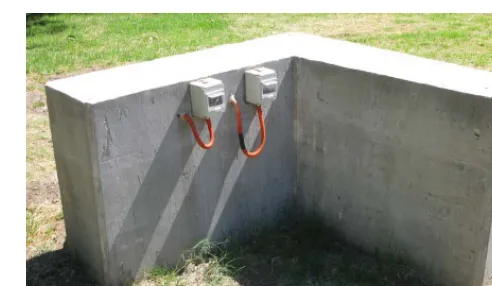 Fig. 1. Instrumented concrete wall simulating the corner of a cell showing the electrical contacts of the embedded sensor