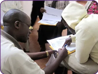 Figure 8:  The infectious disease coordinator explains a new  treatment protocol to a nurse in Rwanda