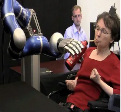 Figure 8. A lady controlling a robotic arm to feed herself 