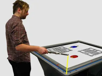 Figure 15. The participant specified perceived angle by manipulating the angle of a string attached to  the right corner of the table and the tip of a wand (string highlighted in yellow)