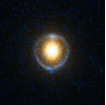 Figure 1.1: Hubble ACS B- and I-band imageof gravitational lens SDSS J232120.93-093910.2.The light of a (blue) background galaxy is de-fected by the (yellow) foreground galaxy toform the Einstein ring
