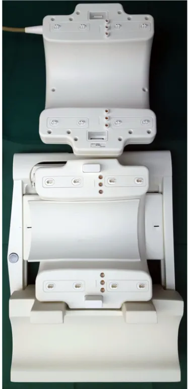 Fig. 2 Photograph of an opened, 28-channel transmit / receive knee coil(Quality Electrodynamics, Mayfield Village, OH) for a 7.0 T MR system(Philips, Best, the Netherlands) that includes the coil as well as a specialadapter box (left) that connects the coil to the MR system