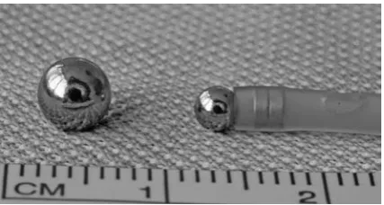 Fig. 1. Spherical magnets (outer diameter 4 and 3 mm) coated with chrome and magnetic insertion catheter produced from an 8-F feeding tube and two small cylindrical magnets inserted into its tip to pull the spherical 3 mm magnet