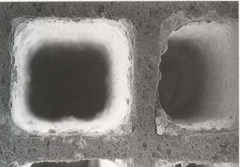 Figure 2.3: Scanning electron micrograph of a ceramic monolith with square shaped a cell that has been coated with washcoat catalyst (Hayes & Kolaczkowski, 1997)  