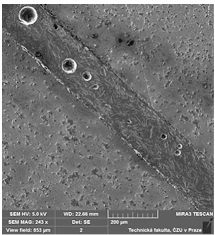 Fig. 6. SEM images of microcracks in boundary adherent S235J0 / adhesive