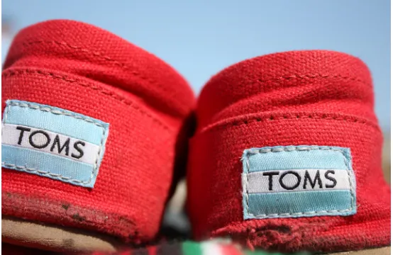 Figure 1.2 A well-worn pair of Toms Shoes; Toms gives away free shoes to a poor child for every Source: Toms Shoes, photo by Vivianna Love (CC BY 2.0, 2009) pair it sells.