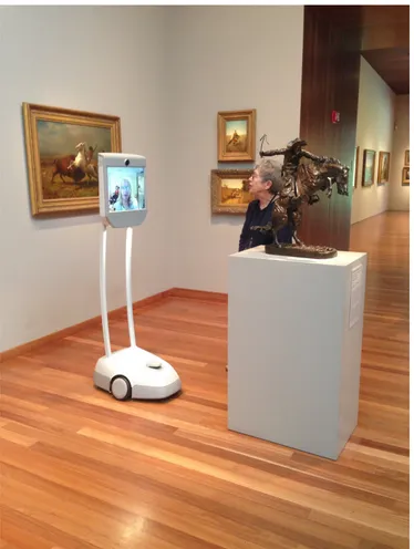 Figure 1 - A museum visitor utilizing the BeamPro at the de Young Museum. She is lead by a volunteer docent