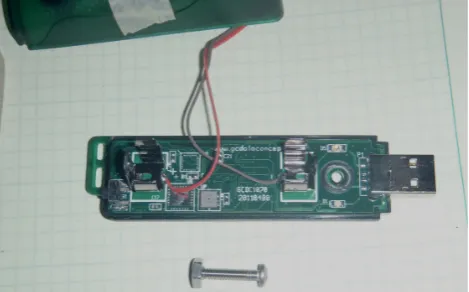 Fig. 1. Datalogger with the casing partly removed. The USB con-nector is at right, the AA battery terminals are visible at right andleft (with user-supplied wires soldered there to provide an alterna-tive power supply in this application)