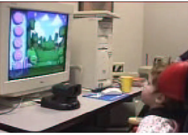 Figure 2: (a) Thirty-month old Camera-Mouse user with cerebral palsy. (b) The visual tracking interface of the vision computer.
