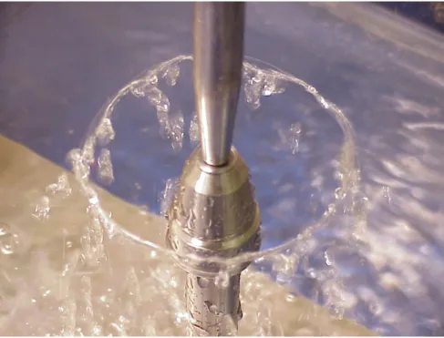 Figure 1: A circular fluid sheet generated by the impact of a water jet on a circular impactor (below)