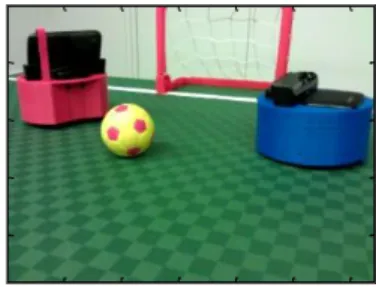 Fig. 1. Image showing the ground field, the ball, one goal and two mobile robot agents