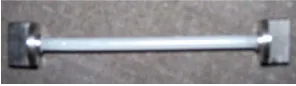 Figure 3. Cylindrical rod sample glued to the special grips.  