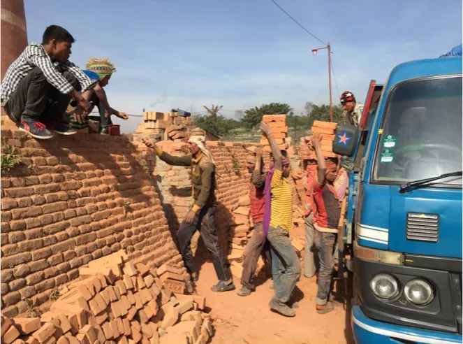 Figure 1. Workers carrying fired bricks. Figure by Steven Thygerson. 