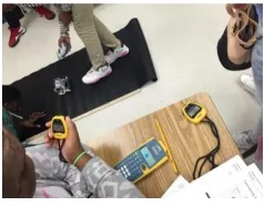 Figure 9.  Student #1 Testing the Robot Operating on a Vinyl Surface. 