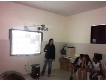 Figure 13. The researcher using the digital whiteboard to explain the rules of game 1 