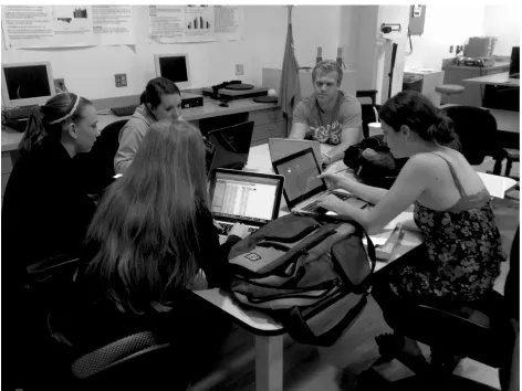Figure 4. Students engaged in the socialization phase of knowledge creation during face-to-face exchange of ideas during laboratory session