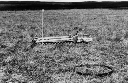 Fig. A3.  Photograph of a newly established lysimeter installation showing uniformity of vegetation inside and outside thetank (right foreground), position of satellite pit marked by almost-vertical valve board and handle (right centre) withpermanent duckb