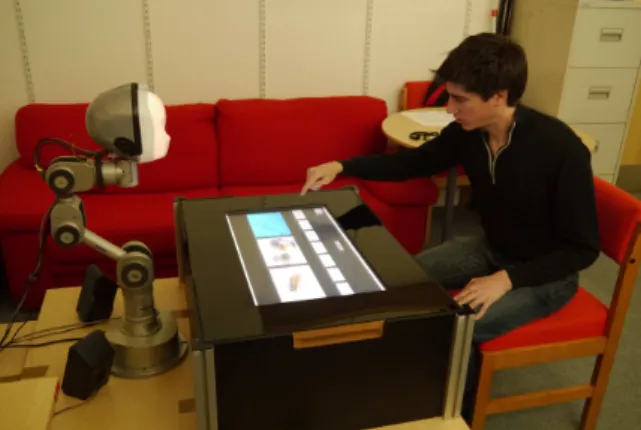 Figure 4. Setup for social learning of word-meaning pairs by a humanoid robot. See Section 3.2.