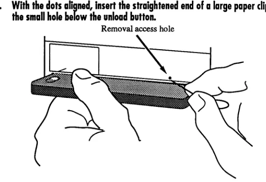 Figure 3-5: Inserting a paper clip in the access hole 