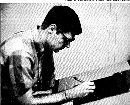 Figure 1. User seated at Graphic Table Display Console. 